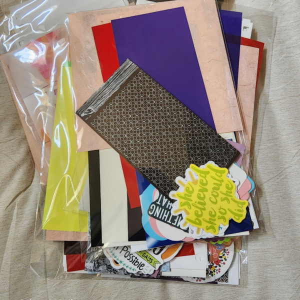 25-piece junk journal paper pack with assorted vintage-inspired papers, cardstock, and colorful craft supplies.