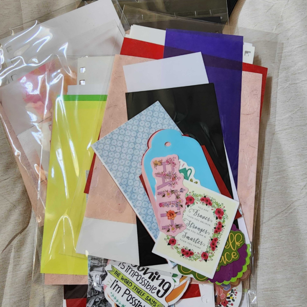 25-piece junk journal paper pack with colorful tags, cardstock, and vintage-inspired paper supplies for scrapbooking and DIY crafts.