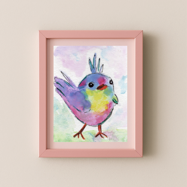 Framed 5x7 rainbow bird art print with pastel colors hanging on a neutral wall